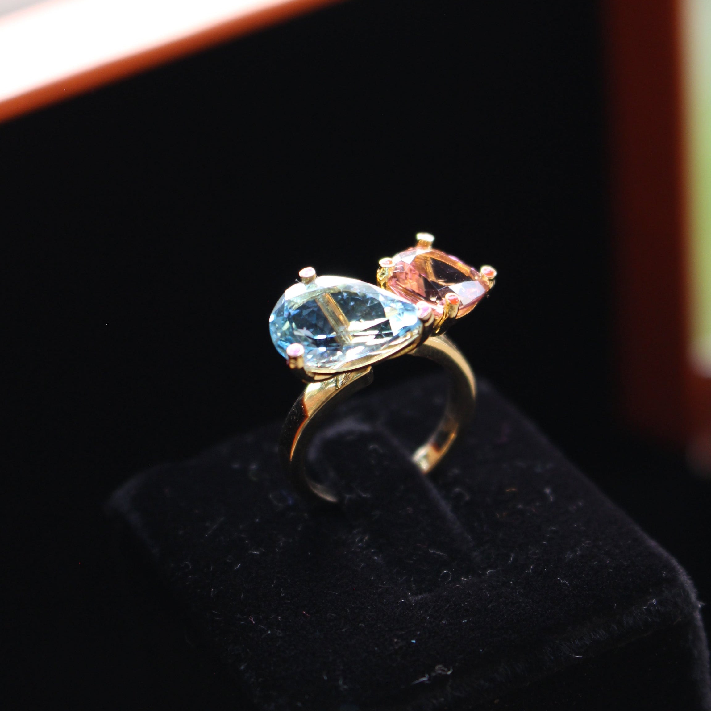 Gold ring with gemstones on a black background